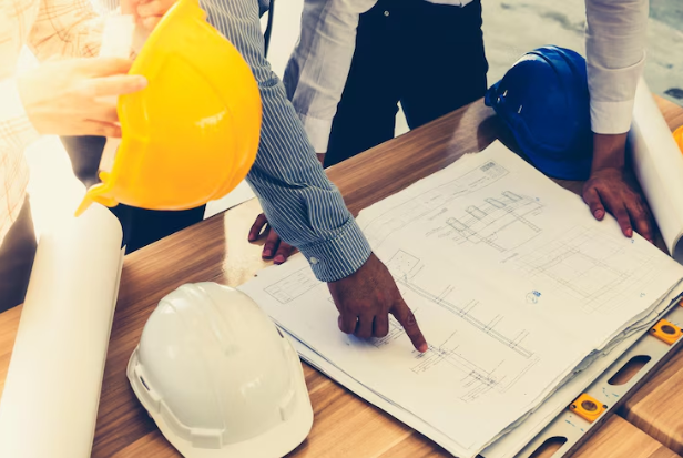 Construction team reviewing project blueprints on site